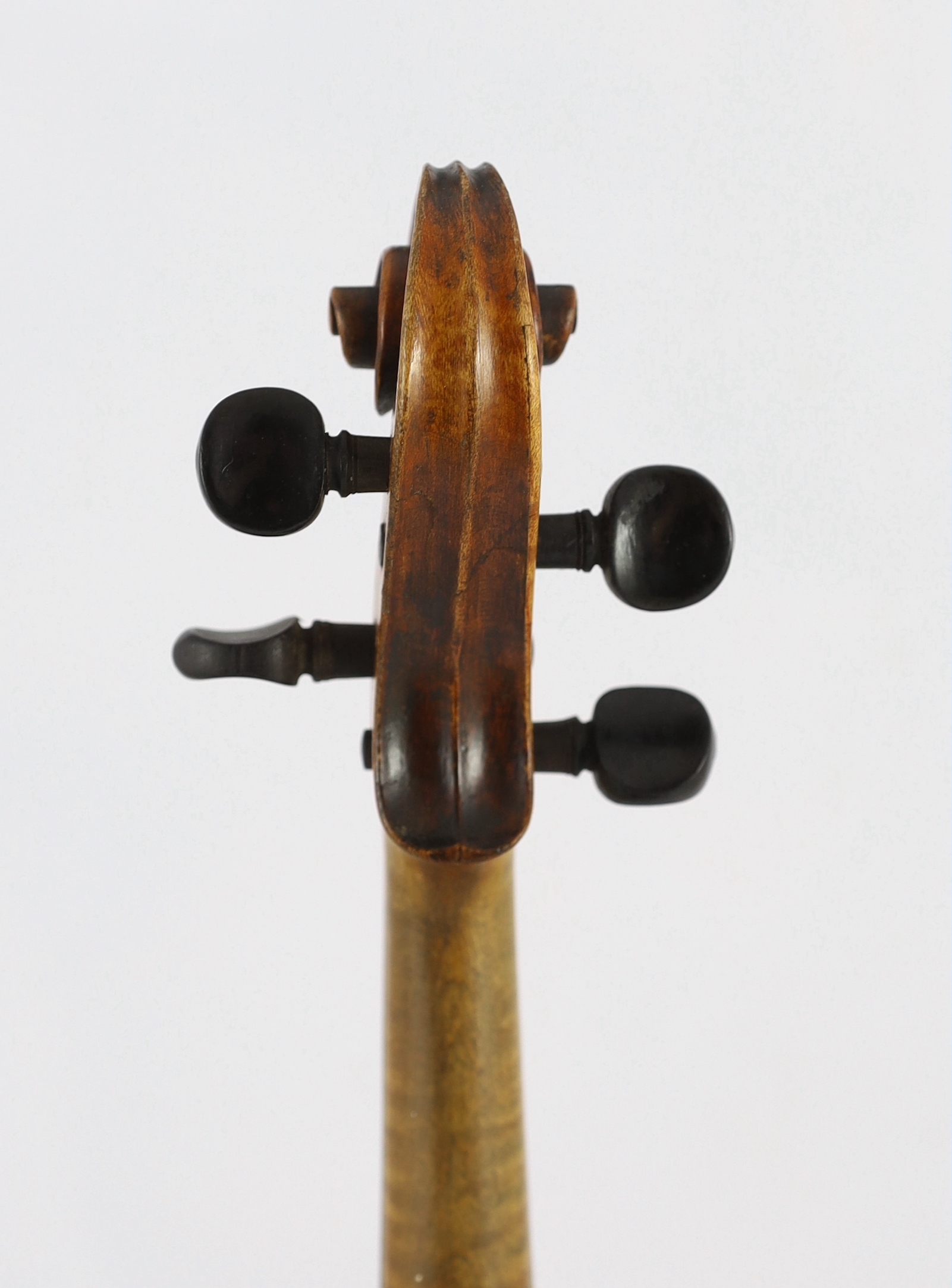 An 18th century violin, labelled ‘New Back by James Carroll, Maker, Manchester 1899’, length of back 36.5cm